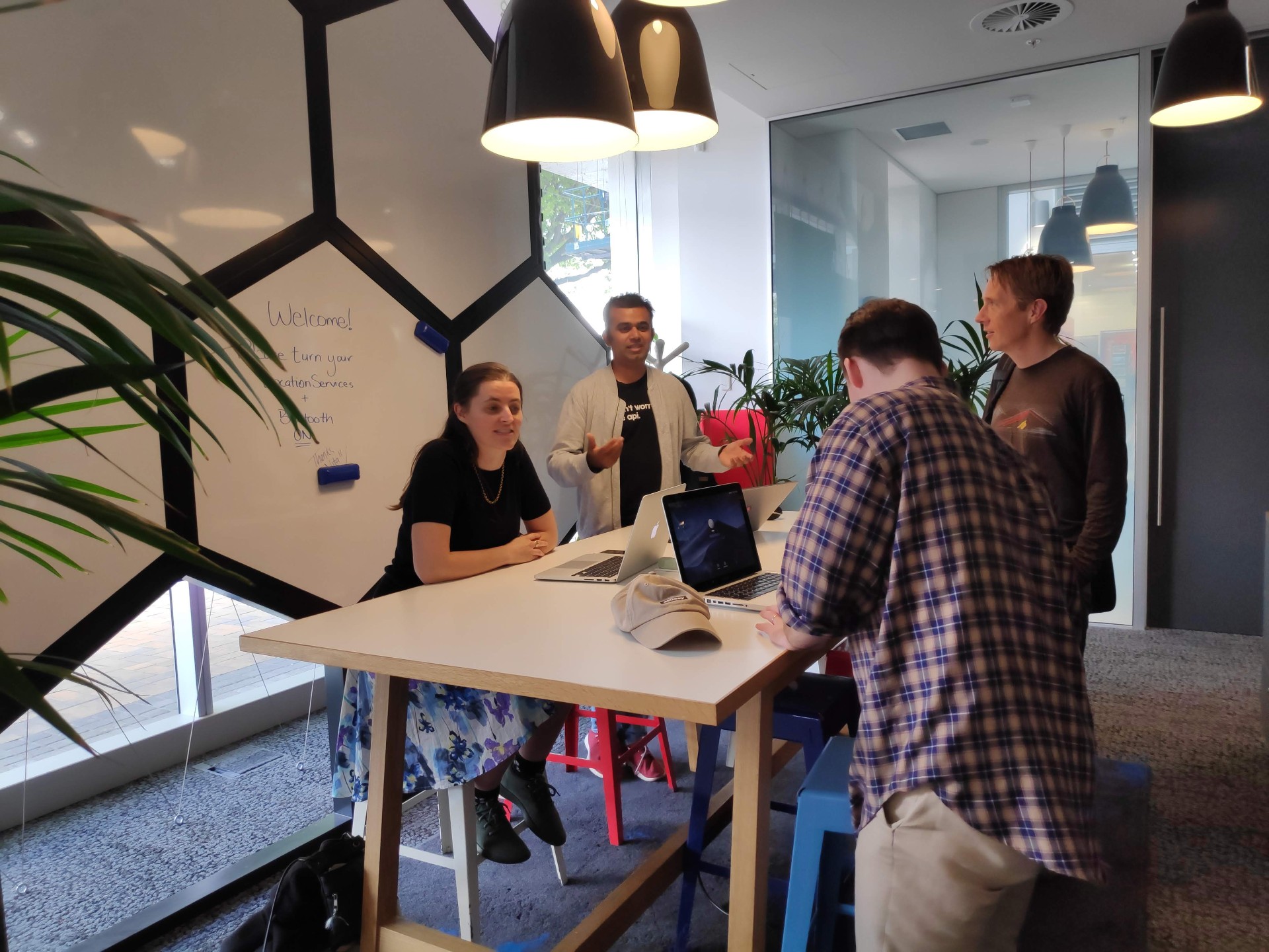 Orchid team collaborating around a whiteboard